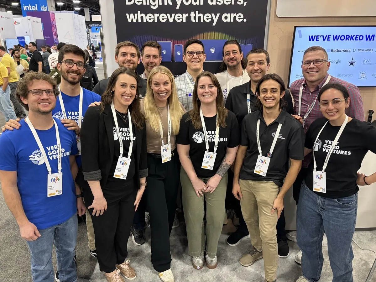 A row of VGV teammates smiling at the Very Good Ventures booth at Google Cloud Next