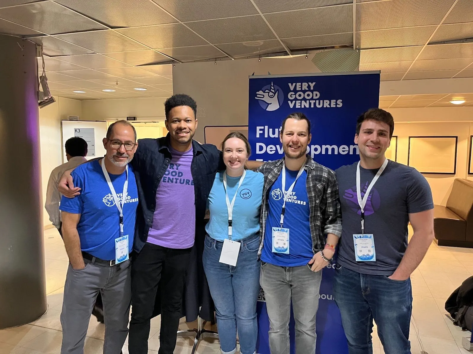 Five VGV teammates in unicorn T-shirts at the Flutter Vikings conference